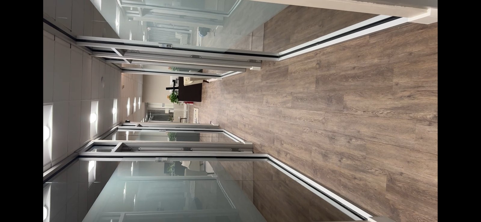 Long commercial corridor with privacy film on glass offices