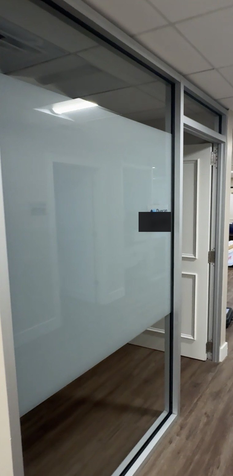 Close-up of frosted privacy film on office glass partition